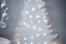 22 a white plywood Christmas tree decorated with lights instantly creates a winter wonderland feel in your home
