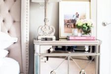 23 a chic and refined mirror bedside table in a glam space with a blush upholstered bed