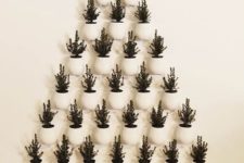 23 a super creative Christmas tree formed of potted evergreens that are attached to the wall