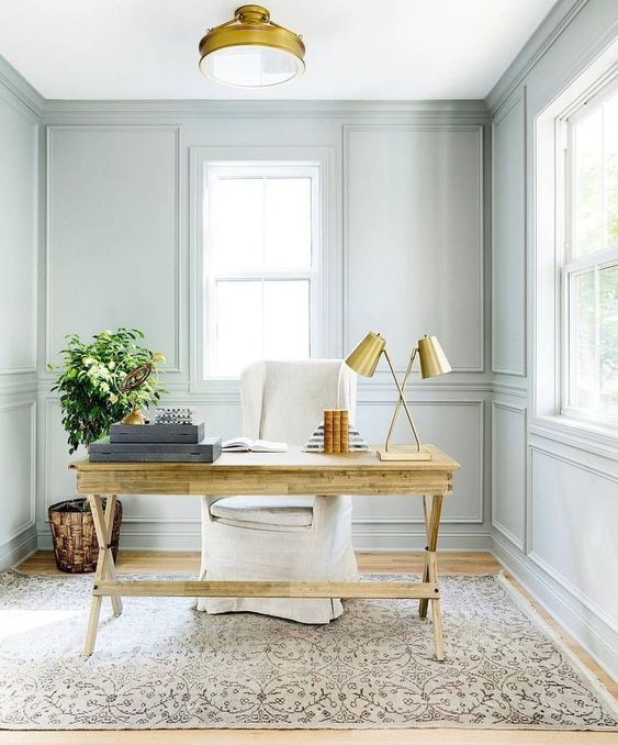 though the wall shade is neutral and pastal, a wooden desk makes the home office cozier