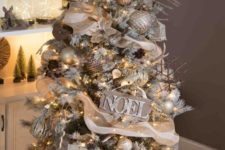 24 a rustic glam Christmas tree decorated with burlap, a vine deer head, wooden signs, stick snowflake ornaments and gold touches