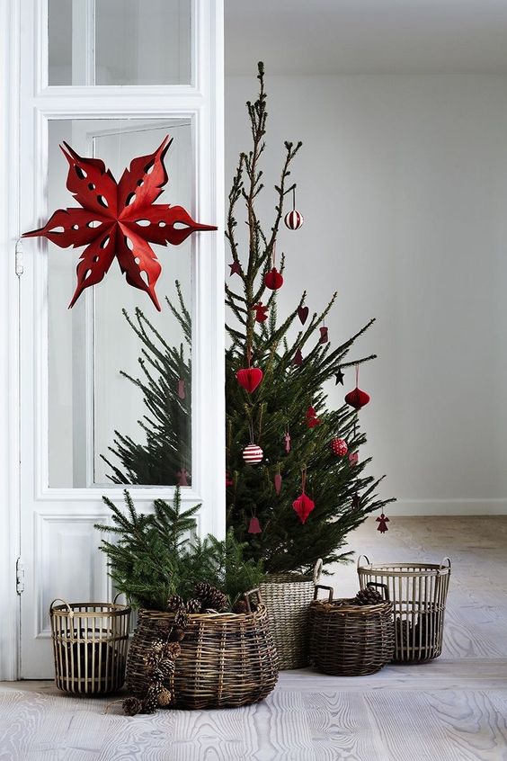 a small tree decorated with red and white ornaments is a gorgeous Scandinavian themed idea