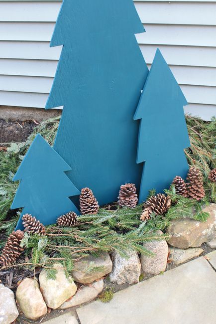 easy plywood trees in blue with evergreens and pinecones are great for creating a simple outdoor display for Christmas