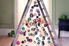 25 a chic ladder christmas tree with colorful ornaments all over and on the floor for a messy and relaxed touch