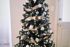 25 a rustic glam Christmas tree with white and silver ornaments, pinecones, icicle ornaments and lights