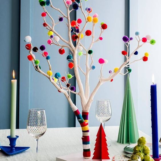 an alternative to a usual Christmas tree, whitewashed branches with colorful washi tape and pompoms