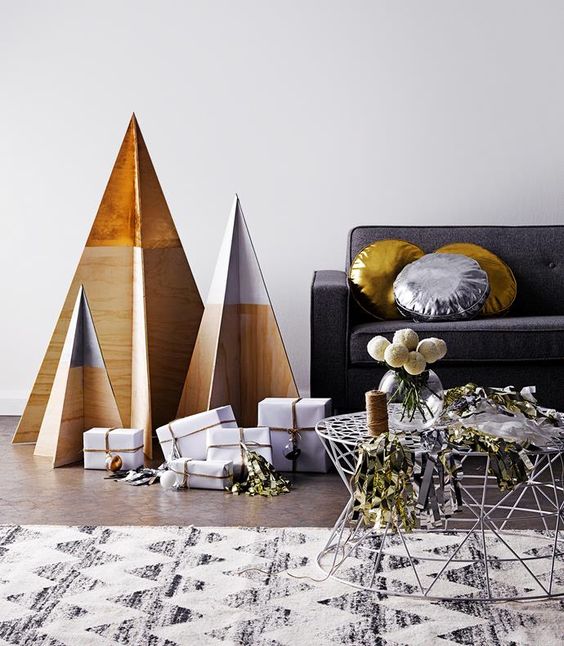 minimalist Christmas trees of plywood with dipped tops are all you need for a laconic interior