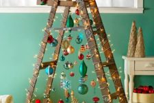 26 a fun Christmas tree of a laddder and colorful ornaments plus lights and a shiny star on top