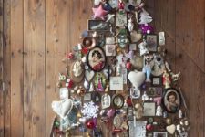 26 a whimsical wall-mounted Christmas tree of figurines, frames, photos and various vintage stuff for a shabby chic space