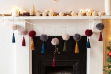 26 colorful pompom and tassel garland plus a garland of white pompoms on the mantel