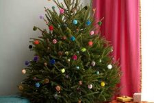 a Christmas tree decorated with colorful pompoms all over is a veyr fun and cool idea that won’t cost you anything