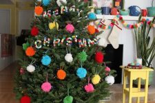 a Christmas tree with colorful pompom ornaments and colorful pompom letters is very awesome