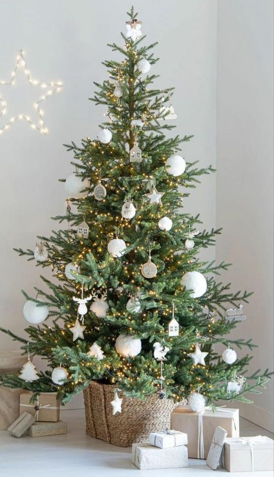 a Nordic Christmas tree decorated with white ornaments, stars, trees, lights and house pieces is cool