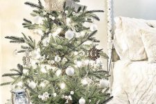 a Scandinavian farmhouse Christmas tree with white ornaments, beads and lights plsu some plywood snowflakes