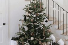 a beautiful Scandinavian Christmas tree decorated with beige, grey and black ornamnets, beads and beaded snowflakes
