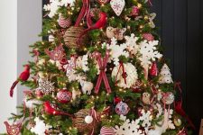 a bold red and white Christmas tree with snowflakes, stars, hearts, trees, skis, vine ornaments and birds