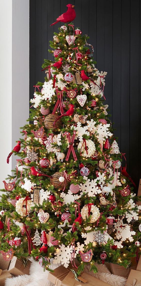 a bold red and white Christmas tree with snowflakes, stars, hearts, trees, skis, vine ornaments and birds