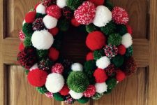 a bright red, green and white pompom Christmas wreath is a cool decor idea for the holidays