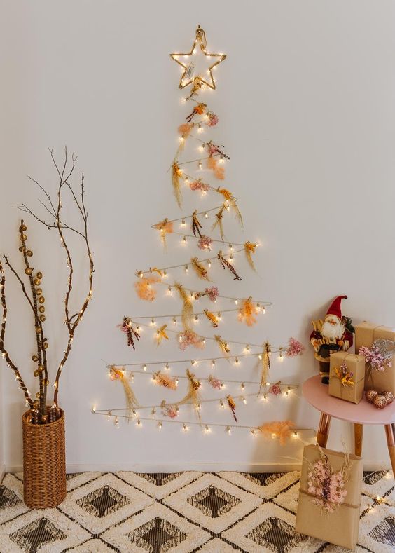 A catchy light wall mounted holiday tree with colorful dried flowers and a star is amazing for Christmas
