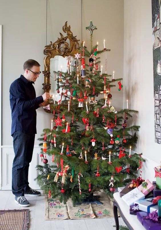 a colorful Scandinavian Christmas tree decorated with bright ornaments and candy canes is a fun and cool idea