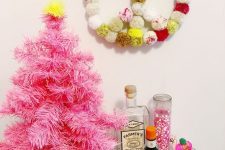 a colorful pompom wreath for boho Christmas decor is a cool and easy craft for winter holidays
