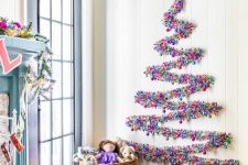 a colorful tinsel wall-mounted Christmas tree can be created on the wall in any space, for example, in an entryway