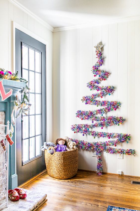 A colorful tinsel wall mounted Christmas tree can be created on the wall in any space, for example, in an entryway