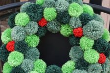 a cool Christmas wreath of pompoms of various shades of green and red is a very Christmassy craft and decoration to rock