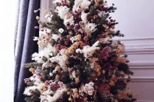 a creative boho Christmas tree with pampas grass, dried blooms and pompoms is a cool and bold solution