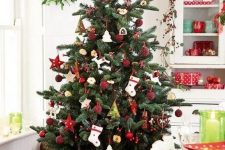 a gorgeous traditional Scandi Christmas tree with red and white ornaments of felt and clay in a basket is a fantastic idea