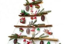 a hanging Christmas tree of branches, evergreens, lights and ornaments is a fresh and catchy solution