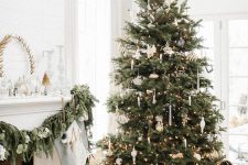 a lovely Scandinavian Christmas tree with faux icicles, candles, some white ornaments and lights