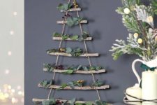 a natural wall-mounted Christmas tree of branches and rope, with eucalyptus and berries is a lovely idea
