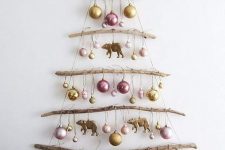 a simple and natural wall Christmas tree of branches and yarn, with pastel ornaments, is a lovely idea