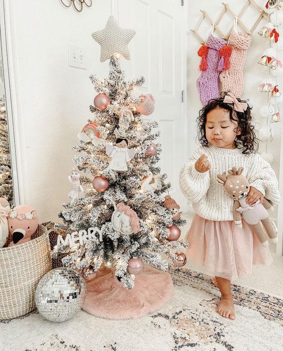 a small Christmas tree decorated with blush ornaments, angels and unicorns is a very cute idea for a little girl's room
