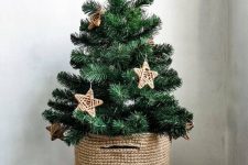 a small Christmas tree in a basket, with twine stars, is a lovely rustic decor idea