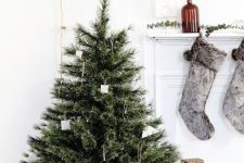 a small Christmas tree with white ornaments and no other decor is a perfect solution for a minimalist space