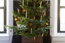 a small vintage Christmas tree with citrus slices and candles is a great rustic decor idea