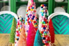a tray with bold tinsel and colorful pompom Christmas trees is a fun decoration or centerpiece for the holidays