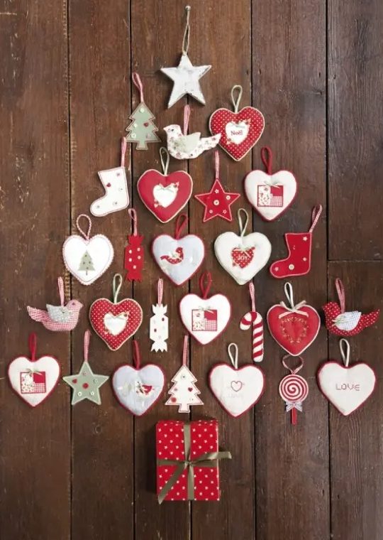 A wall mounted Christmas tree composed of heart, star and tree ornaments in red and white, is amazing