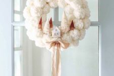 a white pompom Christmas wreath with tinsel trees and a small house plus a silk ribbon bow is very exquisite and cozy