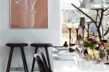 02 The dining space is accented with black chairs, candles, florals and catchy pendant lamps