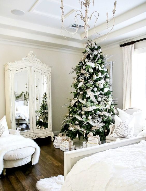 a winter wonderland space with lots of white fur, a silver and white Christmas tree and white furniture