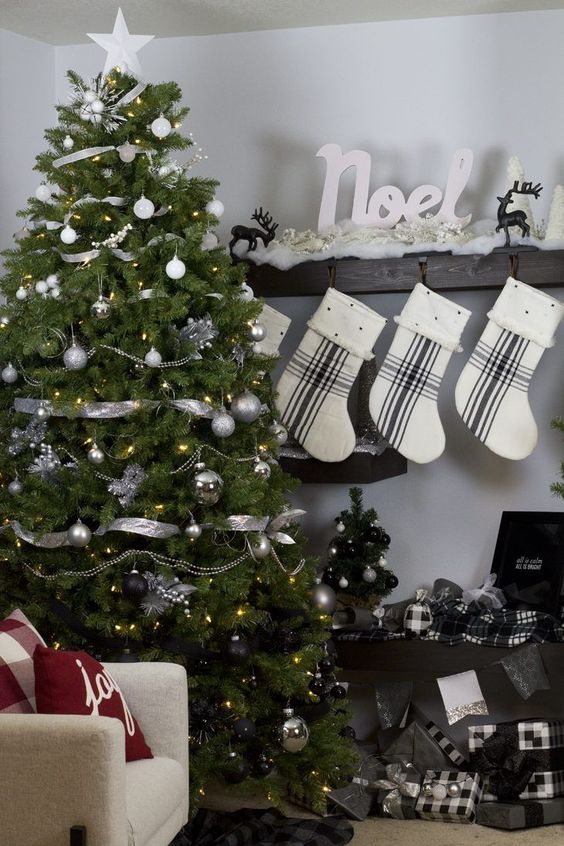 an ultra modern Christmas tree from white and silver to black plus silver ribbon and lights for a monochromatic space