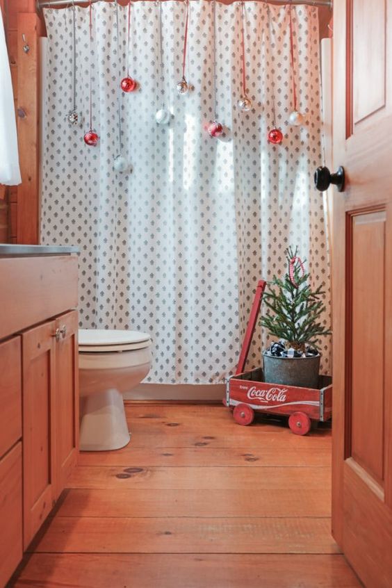 avoid using floor space as there isn't much in a bathroom, hang ornaments on the shower curtain for a festive feel