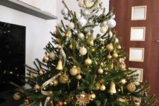 03 a beautiful and luxurious ombre silver to gold and copper Christmas tree with lights and a star on top looks very chic