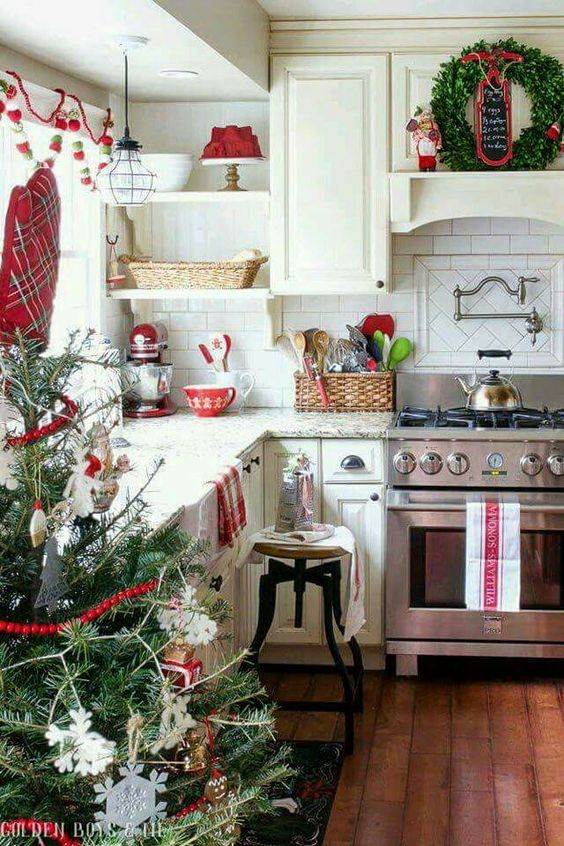 a neutral kitchen was spruced up with reds and evergreens and looks very natural and holiday-like