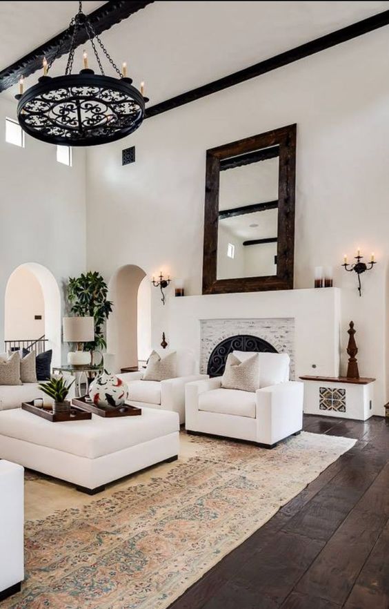 white plaster walls make up a great base for a Mediterranean space, dark wooden floors will contrast them