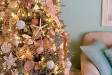 04 a different coastal Christmas tree with pinks, glitter, metallics, starfish and nets is a very creative idea