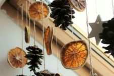 04 a garland of dried citrus and pinecones is a simple DIY idea to make your space more hygge